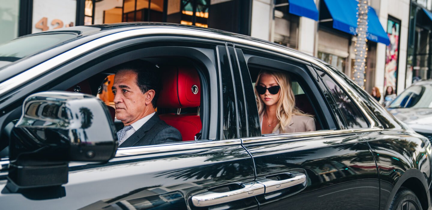 Photo of a sedan with a driver and passenger